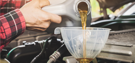 Engine oil pouring through a funnel