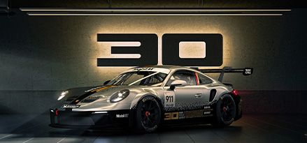 Porsche 911 GT3 Cup with a 30th birthday sign in the background