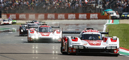 Porsche racing cars on a track