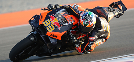 Motorcyclist on a Red Bull motorbike going round a corner very quickly