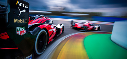 Porsche racing car going round a corner on a racing track