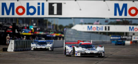Porsche racing car going round a corner on a racing track