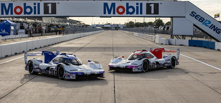 two static Porsche race cars on track image