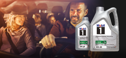 Family in a car with two Mobil 1 Hybrid 0W-20 motor oil containers in the foreground.